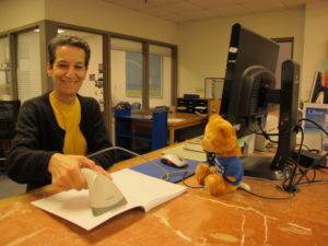 Celia checks out a book for Dove