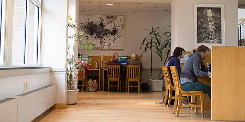 students working on computers in the library