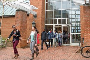 Student leaving the front door of Library building